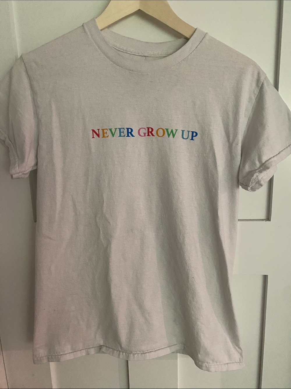 White Short Sleeve Tee — Baylen Levine "Never Grow Up" Rainbow Text
